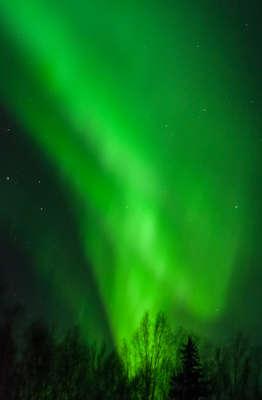 An aurora swirls up from the horizon like an icecream cone.の写真素材