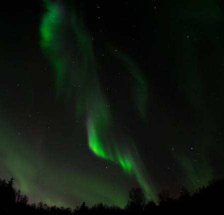 A ribbon of light is the result of an aurora racing across the sky.の写真素材