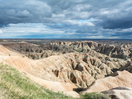 Grey Clouds swept over the dry ravines of the Bad Lands.の写真素材