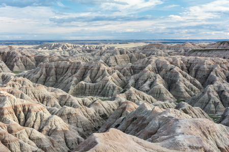 Erosion has revealed stripes of brown rock in sandstone ridges of the Badlands.の写真素材