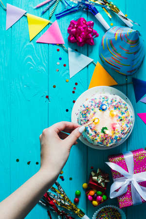 Happy Birthday day cupcake and cake bakery with candles, bright lights bokeh. Background holiday...