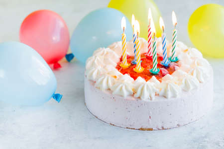 Happy Birthday day cupcake and cake bakery with candles, bright lights bokeh. Background holiday...