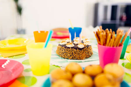 Happy birthday table concept background with cake and candle.の写真素材