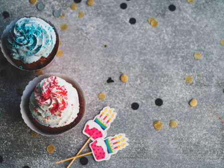 Happy Birthday day cupcake and cake bakery with candles, bright lights bokeh. Background holiday...