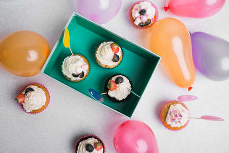 Happy Birthday day cupcake and cake bakery with candles, bright lights bokeh. Background holiday...