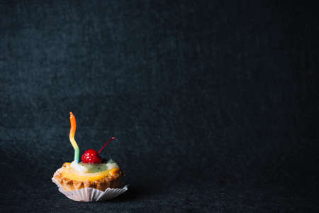 Happy Birthday day cupcake and cake bakery with candles, bright lights bokeh. Background holiday...