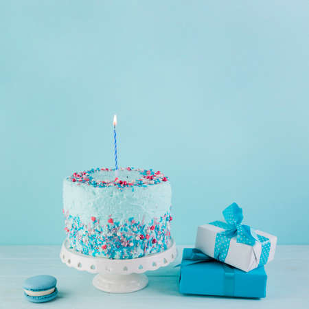 Happy Birthday day cupcake and cake bakery with candles, bright lights bokeh. Background holiday...