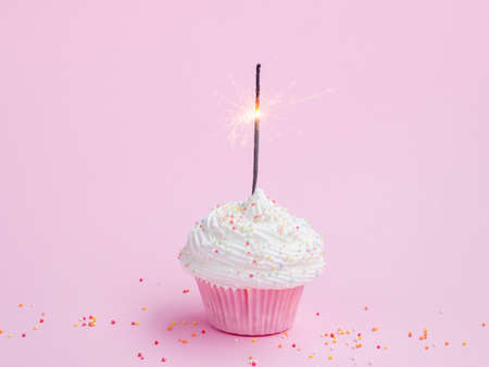 Happy birthday day cake or cupcake with candles and light. Background with place for text.の写真素材
