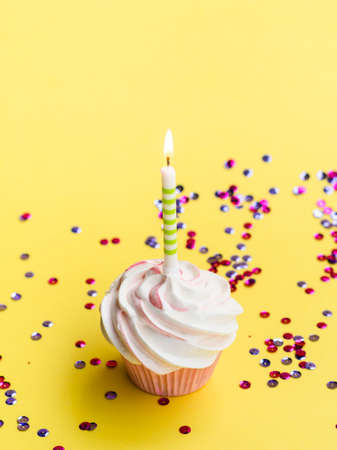 Happy birthday day cake or cupcake with candles and light. Background with place for text.の写真素材