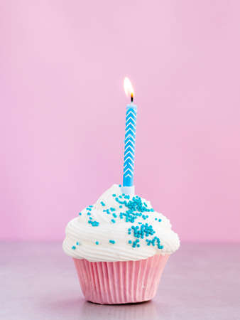 Happy birthday day cake or cupcake with candles and light. Background with place for text.の写真素材