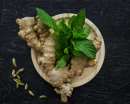 Various herbs spices with place for text isolated dark background, plate. Top view.