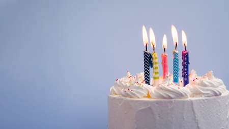 Happy birthday day cake or cupcake with candles and light. Background with place for text.の写真素材
