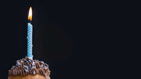 Happy birthday day cake or cupcake with candles and light. Background with place for text.
