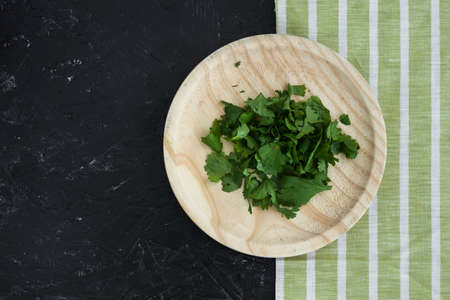 Various herbs spices with place for text isolated dark background, plate. Top view.
