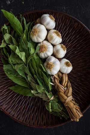 Various herbs spices with place for text isolated dark background, plate. Top view.の写真素材
