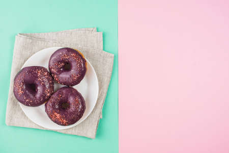 Abstract colorful donuts bakery, sweet concept background with place for text. Top view. Glazed...