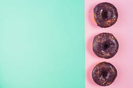 Abstract colorful donuts bakery, sweet concept background with place for text. Top view. Glazed donuts on color background.の写真素材