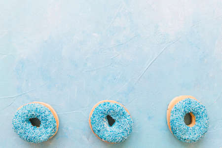 Abstract colorful donuts bakery, sweet concept background with place for text. Top view. Glazed donuts on color background.の写真素材