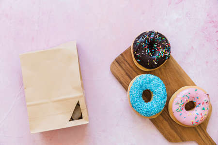 Abstract colorful donuts bakery, sweet concept background with place for text. Top view. Glazed...