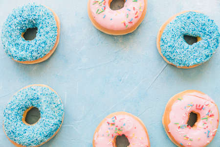 Abstract colorful donuts bakery, sweet concept background with place for text. Top view. Glazed...
