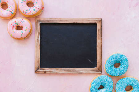 Abstract colorful donuts bakery, sweet concept background with place for text. Top view. Glazed donuts on color background.の写真素材