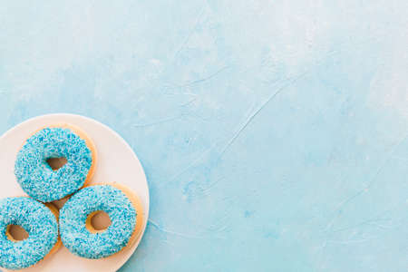 Abstract colorful donuts bakery, sweet concept background with place for text. Top view. Glazed donuts on color background.の写真素材