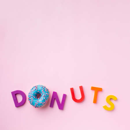 Abstract colorful donuts bakery, sweet concept background with place for text. Top view. Glazed...