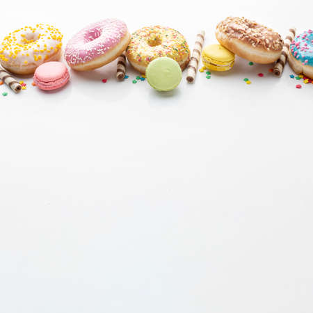 Abstract colorful donuts bakery, sweet concept background with place for text. Top view. Glazed donuts on color background.の写真素材
