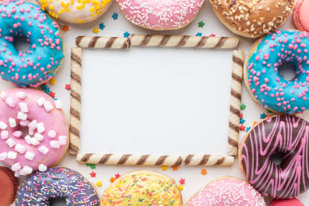 Abstract colorful donuts bakery, sweet concept background with place for text. Top view. Glazed...