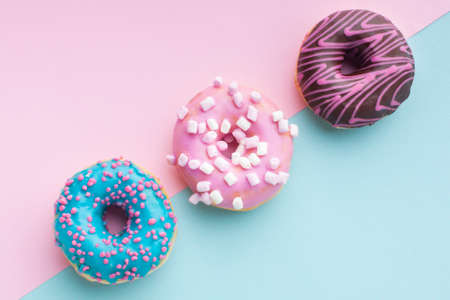 Abstract colorful donuts bakery, sweet concept background with place for text. Top view. Glazed...