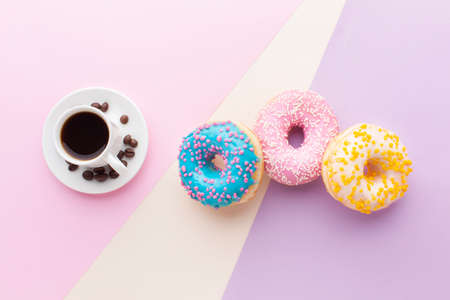 Abstract colorful donuts bakery, sweet concept background with place for text. Top view. Glazed donuts on color background.の写真素材