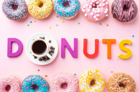 Abstract colorful donuts bakery, sweet concept background with place for text. Top view. Glazed...
