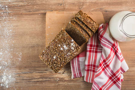 Different baking buns, croissants, gingerbread cookies. Delicious freshly baked bread on wooden...