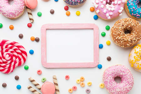 Abstract colorful donuts bakery, sweet concept background with place for text. Top view. Glazed donuts on color background.の写真素材
