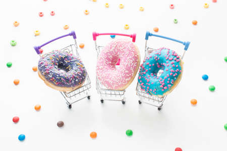 Abstract colorful donuts bakery, sweet concept background with place for text. Top view. Glazed donuts on color background.の写真素材