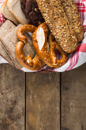 Different baking buns, croissants, gingerbread cookies. Delicious freshly baked bread on wooden...