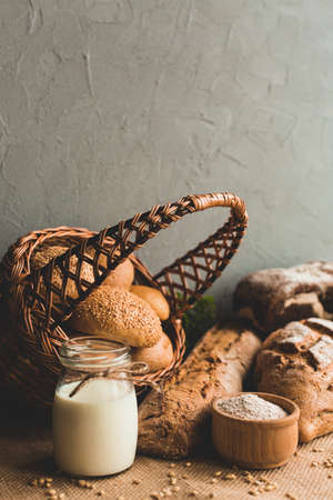 Different baking buns, croissants, gingerbread cookies. Delicious freshly baked bread on wooden...