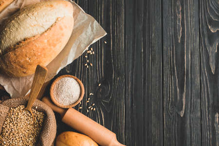 Different baking buns, croissants, gingerbread cookies. Delicious freshly baked bread on wooden...