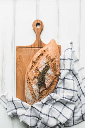 Different baking buns, croissants, gingerbread cookies. Delicious freshly baked bread on wooden background with place for text. Fresh loaves of bread And sliced ââbreads containing sesame seeds.の写真素材