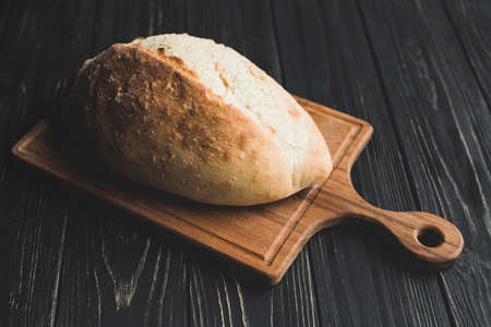 Different baking buns, croissants, gingerbread cookies. Delicious freshly baked bread on wooden...