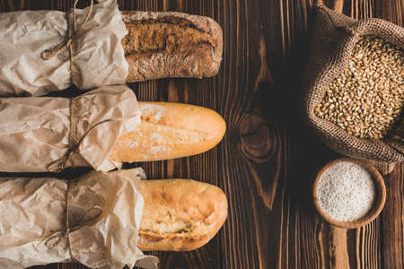 Different baking buns, croissants, gingerbread cookies. Delicious freshly baked bread on wooden...
