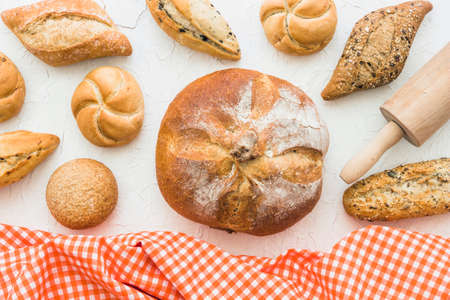 Different baking buns, croissants, gingerbread cookies. Delicious freshly baked bread on wooden...