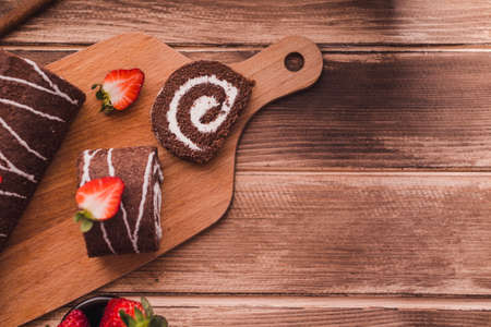Sponge cake roll with chocolate and strawberryの写真素材