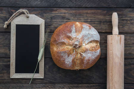 Different baking buns, croissants, gingerbread cookies. Delicious freshly baked bread on wooden background with place for text. Fresh loaves of bread And sliced ââbreads containing sesame seeds.の写真素材