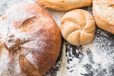 Different baking buns, croissants, gingerbread cookies. Delicious freshly baked bread on wooden...