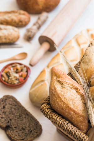 Different baking buns, croissants, gingerbread cookies. Delicious freshly baked bread on wooden...