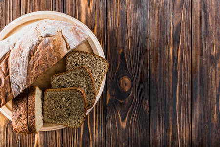 Different baking buns, croissants, gingerbread cookies. Delicious freshly baked bread on wooden...