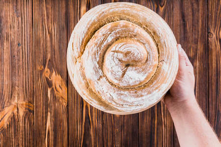 Different baking buns, croissants, gingerbread cookies. Delicious freshly baked bread on wooden background with place for text. Fresh loaves of bread And sliced ââbreads containing sesame seeds.の写真素材