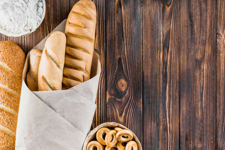 Different baking buns, croissants, gingerbread cookies. Delicious freshly baked bread on wooden...