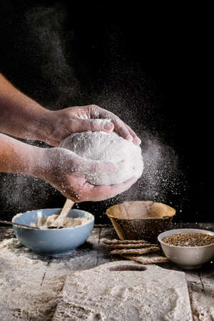 Beat flour and kitchen utensils, a baking dish, a rolling pin with eggs on the table. Baking, cooking concept. Chef making bread and gingerbread cookies. The cook kneads and rolls the dough.の写真素材